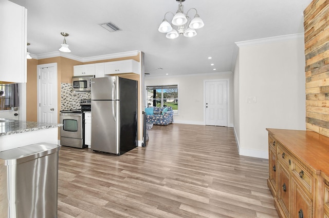 kitchen featuring appliances with stainless steel finishes, backsplash, light hardwood / wood-style floors, white cabinets, and decorative light fixtures