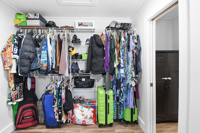 walk in closet with hardwood / wood-style floors