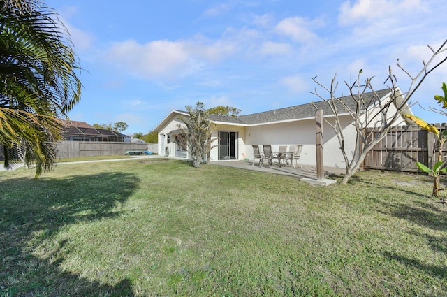 back of house featuring a yard and a patio area