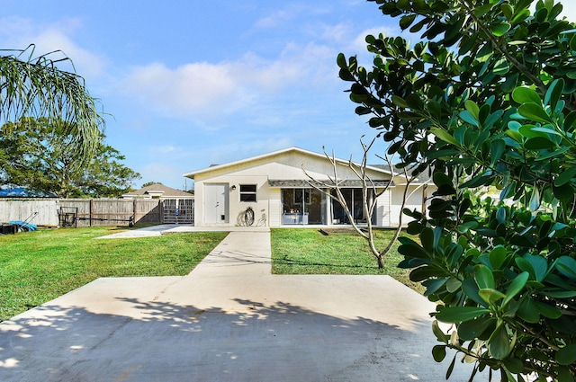 rear view of property featuring a lawn