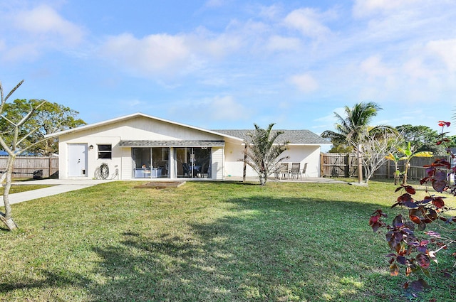 single story home with a front yard and a patio area