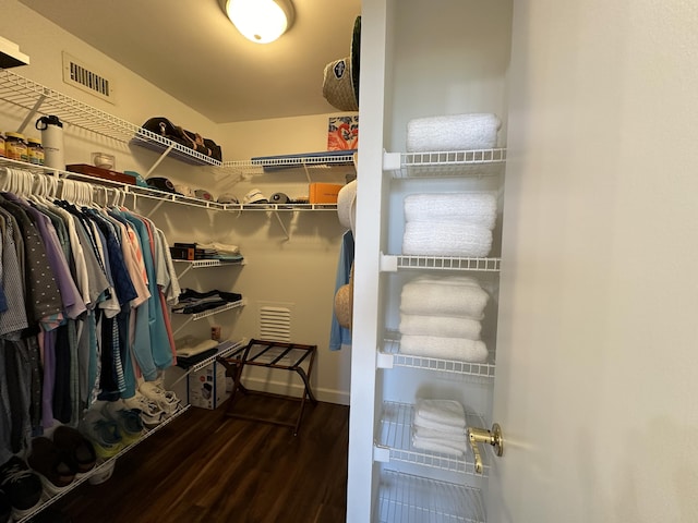 walk in closet featuring dark wood-type flooring