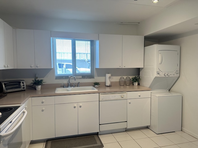 kitchen with white cabinetry, sink, white appliances, and stacked washer and dryer