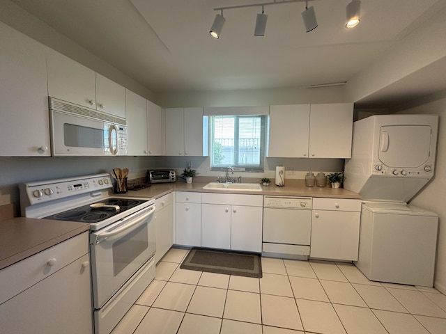 kitchen featuring white cabinetry, sink, stacked washer / drying machine, and white appliances