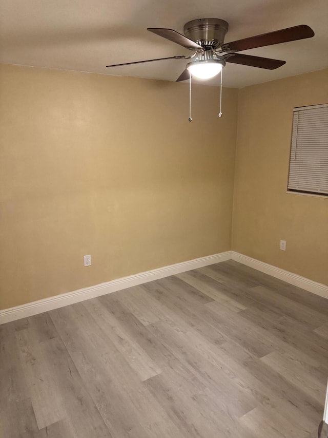 empty room featuring ceiling fan and light hardwood / wood-style floors