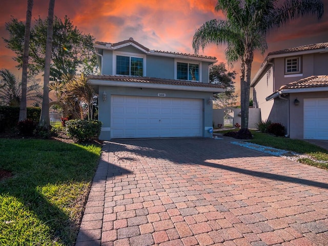 view of front of house with a garage and a lawn