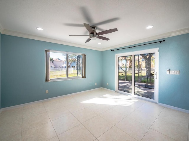 empty room featuring crown molding, a healthy amount of sunlight, and light tile patterned flooring