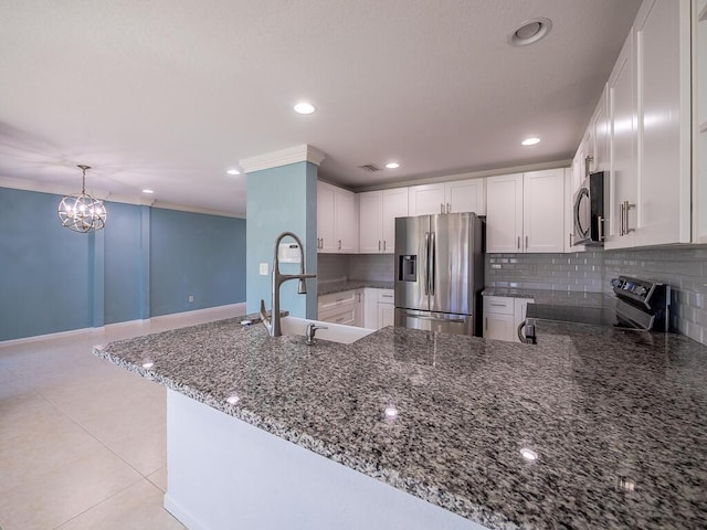 kitchen featuring kitchen peninsula, white cabinets, and appliances with stainless steel finishes