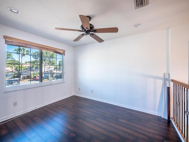 unfurnished room with dark wood-type flooring