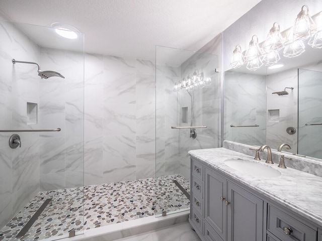 bathroom featuring vanity and tiled shower