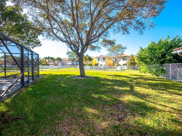 view of yard featuring glass enclosure