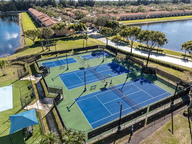 view of tennis court featuring a water view