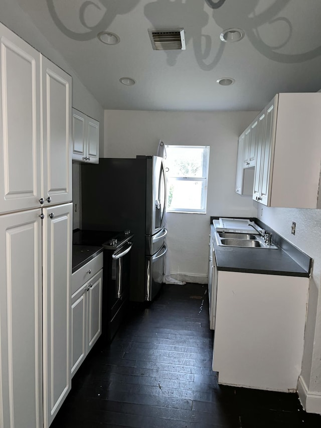 kitchen featuring dark hardwood / wood-style floors, sink, black electric range, and white cabinets