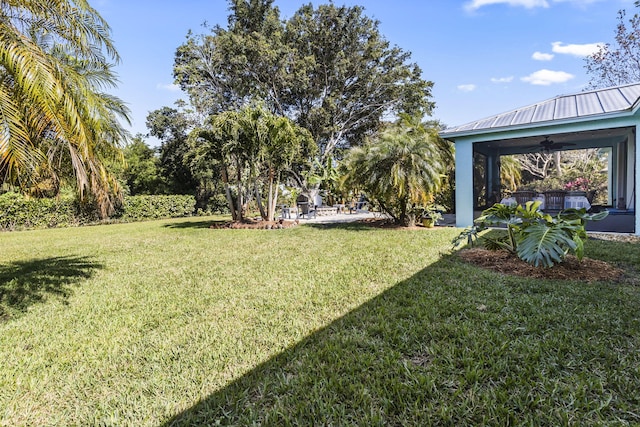 view of yard with ceiling fan