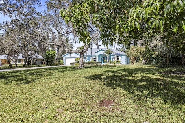 view of front of property with a garage and a front yard