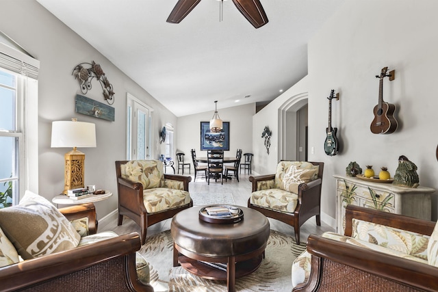 living room with light hardwood / wood-style flooring, vaulted ceiling, and ceiling fan