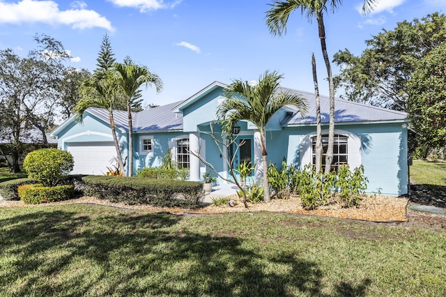 ranch-style home featuring a garage and a front lawn