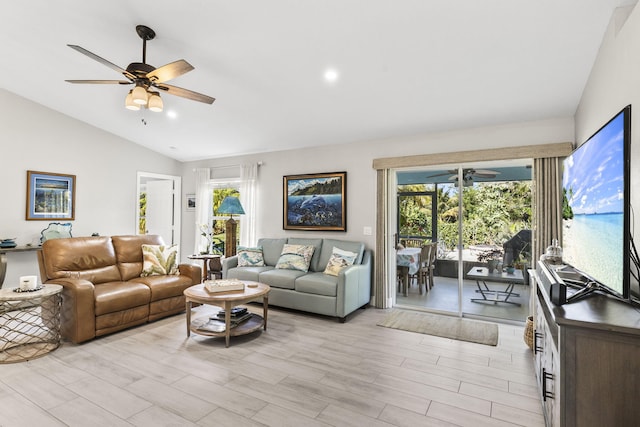 living room with lofted ceiling, light wood-type flooring, and ceiling fan