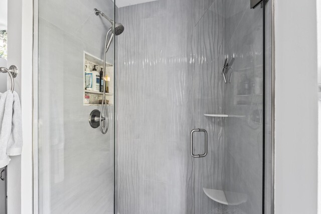 bathroom featuring vanity, hardwood / wood-style floors, and a shower with door