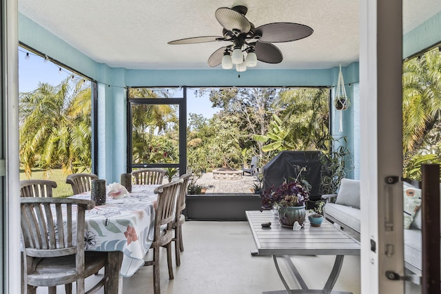 sunroom / solarium with plenty of natural light and ceiling fan