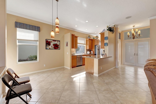 kitchen featuring light tile patterned floors, appliances with stainless steel finishes, ornamental molding, kitchen peninsula, and french doors