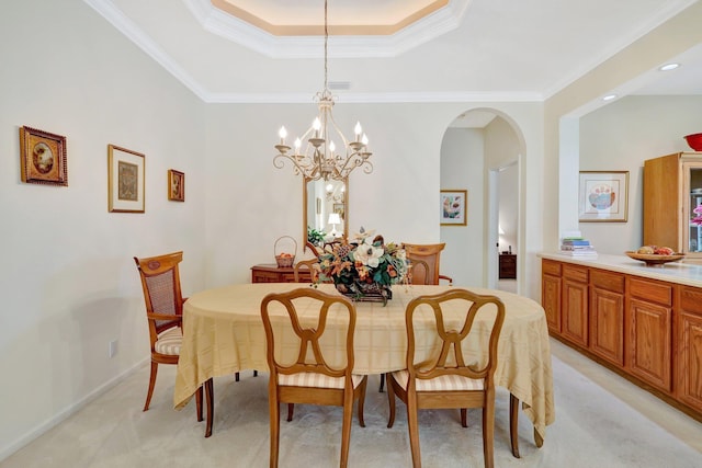 dining area with a raised ceiling, crown molding, and light carpet