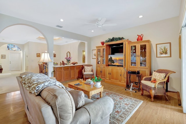 living room with light hardwood / wood-style floors and ceiling fan