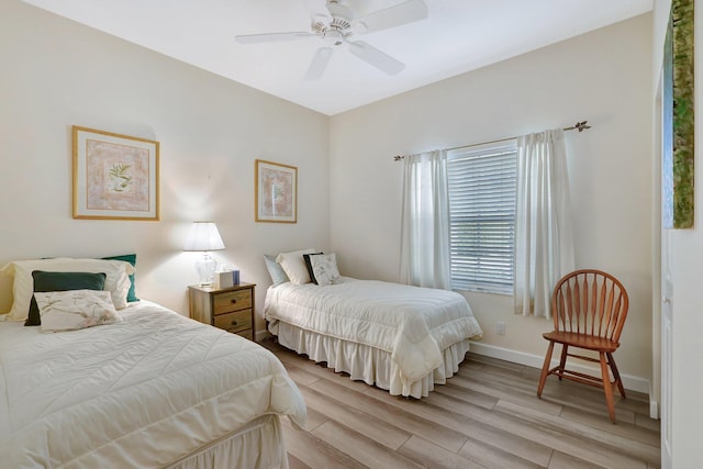 bedroom with ceiling fan and light wood-type flooring