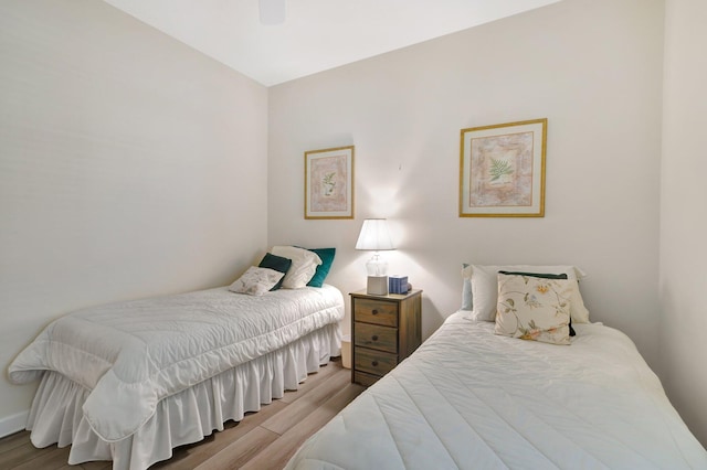 bedroom featuring light hardwood / wood-style floors and ceiling fan