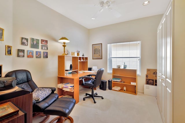 office space with light carpet and ceiling fan