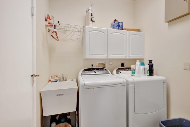 laundry room with sink, cabinets, and independent washer and dryer