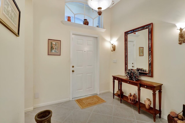 tiled foyer featuring a towering ceiling