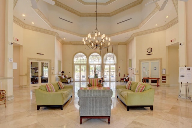 living room featuring french doors, an inviting chandelier, crown molding, a tray ceiling, and a towering ceiling