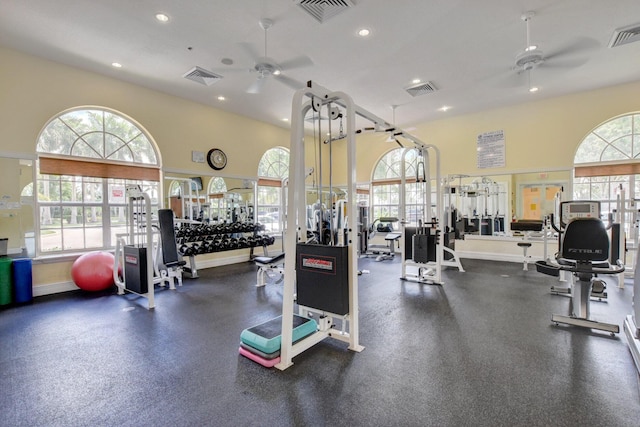 exercise room featuring ceiling fan and a wealth of natural light