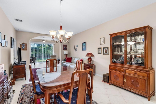 tiled dining space with an inviting chandelier