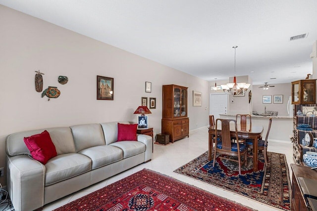 living room with ceiling fan with notable chandelier and light tile patterned floors