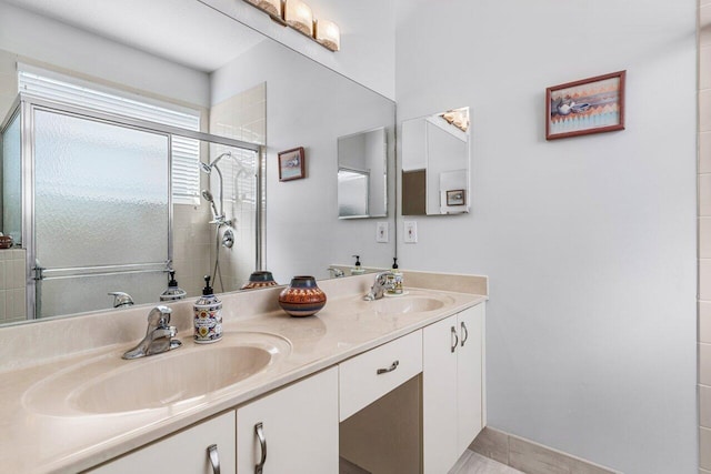 bathroom with a shower with door and vanity