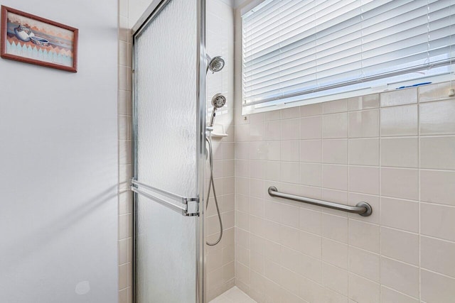 bathroom with a shower with door