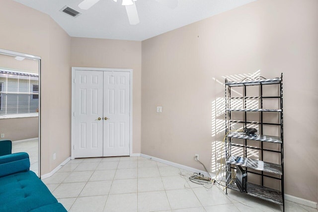 interior space with light tile patterned flooring and ceiling fan