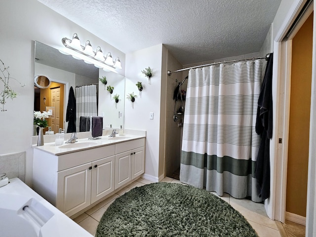 bathroom with vanity, a shower with curtain, tile patterned floors, and a textured ceiling