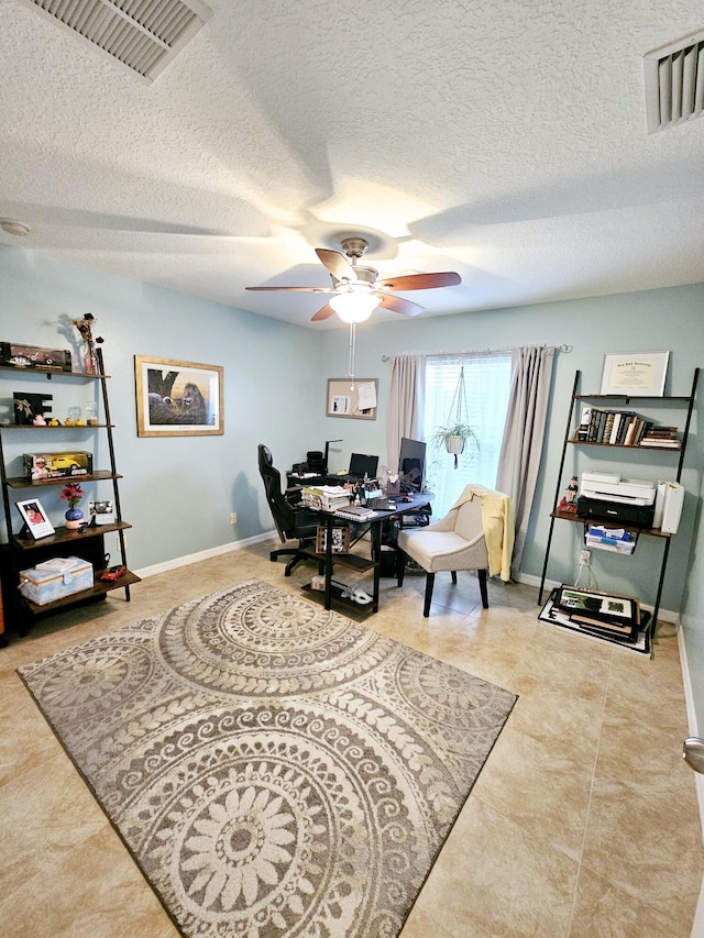 office space featuring ceiling fan, tile patterned floors, and a textured ceiling