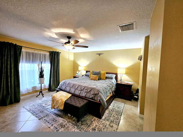 bedroom with light tile patterned floors, a textured ceiling, and ceiling fan