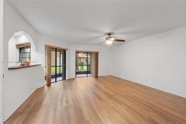 unfurnished room featuring ceiling fan, a textured ceiling, and light hardwood / wood-style flooring