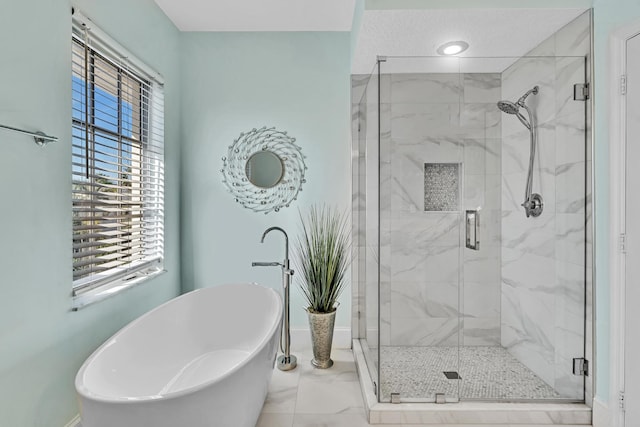 bathroom featuring separate shower and tub