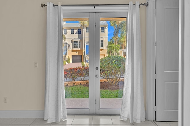 entryway with light tile patterned floors and french doors