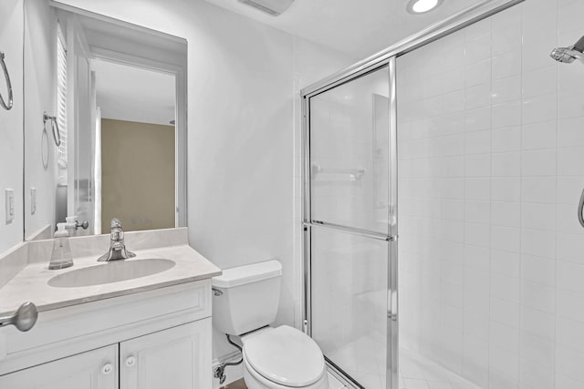 bathroom with vanity, walk in shower, and toilet