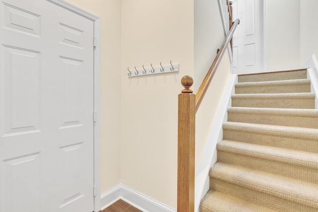 stairway featuring wood-type flooring