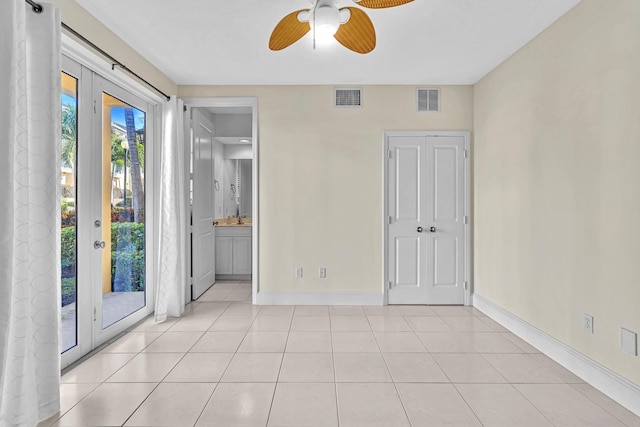 unfurnished bedroom with access to exterior, french doors, ceiling fan, and light tile patterned flooring