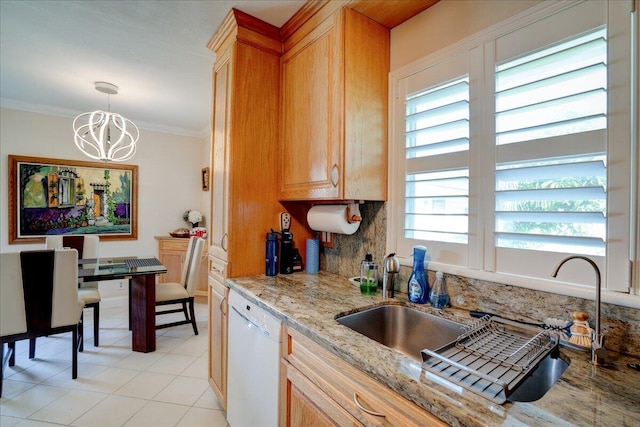 kitchen with light stone counters, hanging light fixtures, ornamental molding, dishwasher, and backsplash