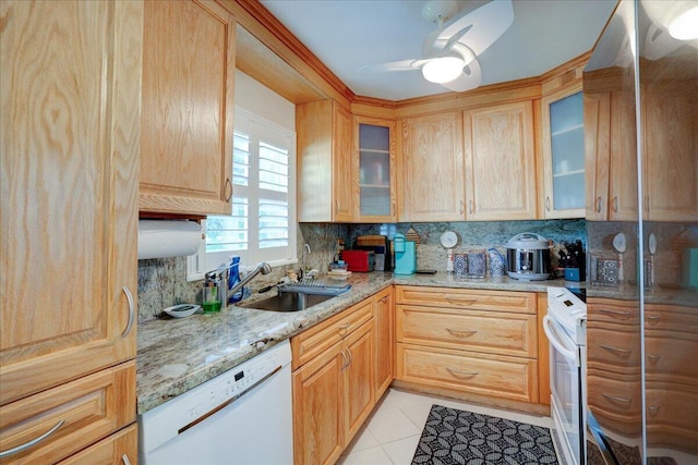 kitchen with light tile patterned flooring, sink, decorative backsplash, light stone counters, and white appliances